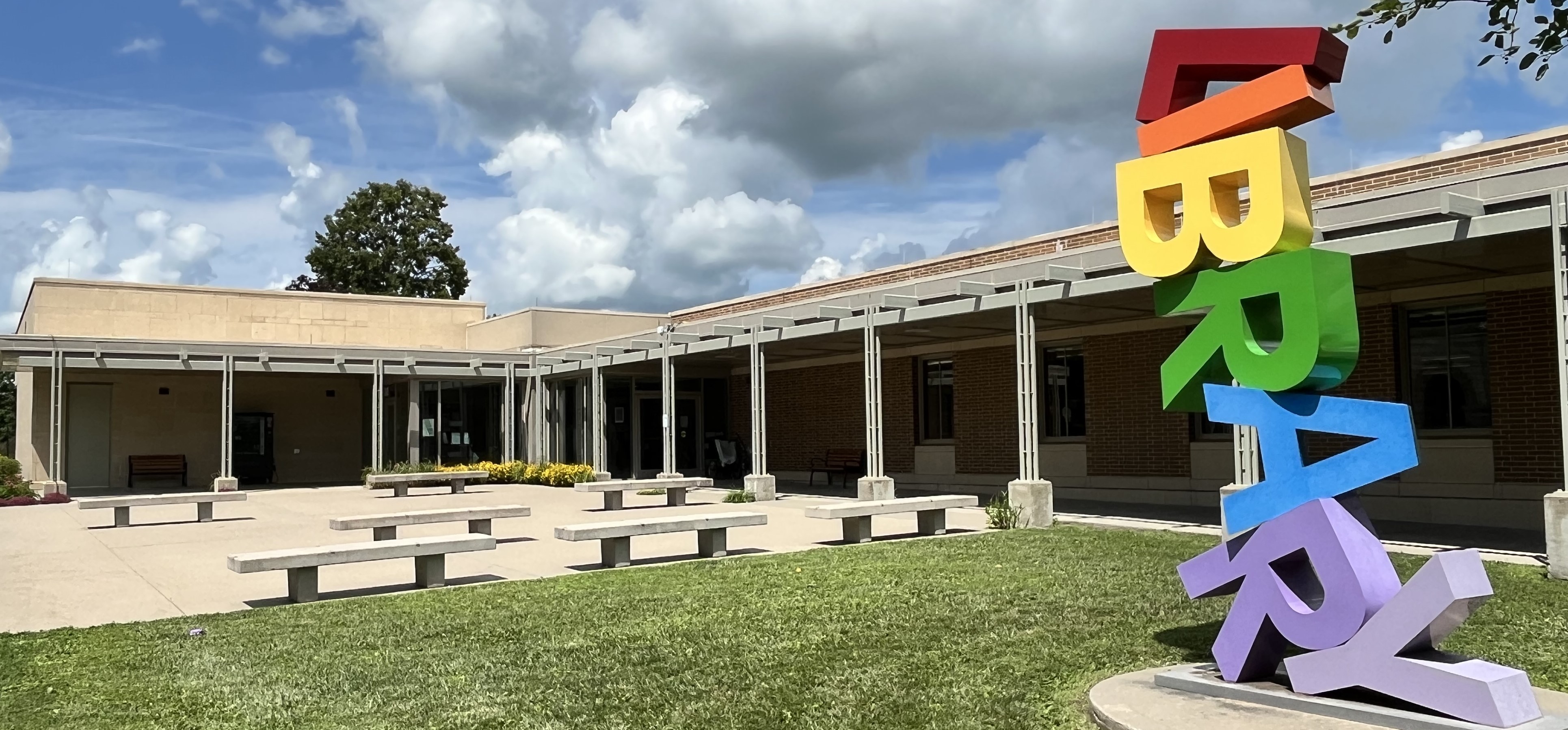 Drake Community Library entrance with colorful "LIBRARY" sculpture