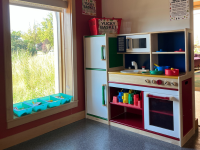 Play Kitchen with play kitchen supplies and oven in the library