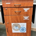 Brown locked cabinet with a "Preservation Station" sign on the front