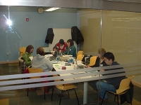 Looking through glass doors at a group of people surrounding a large table